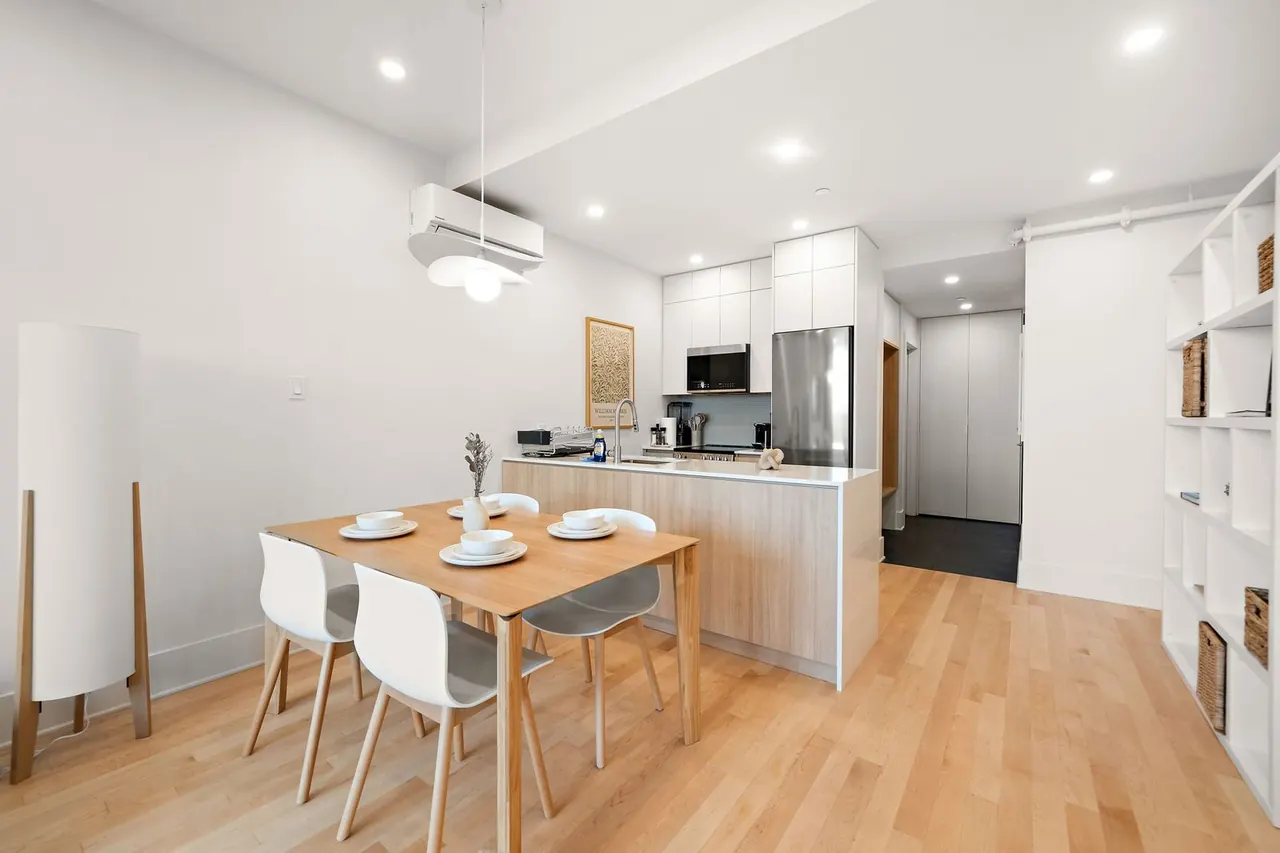 Dining nook with wood table and kitchen island